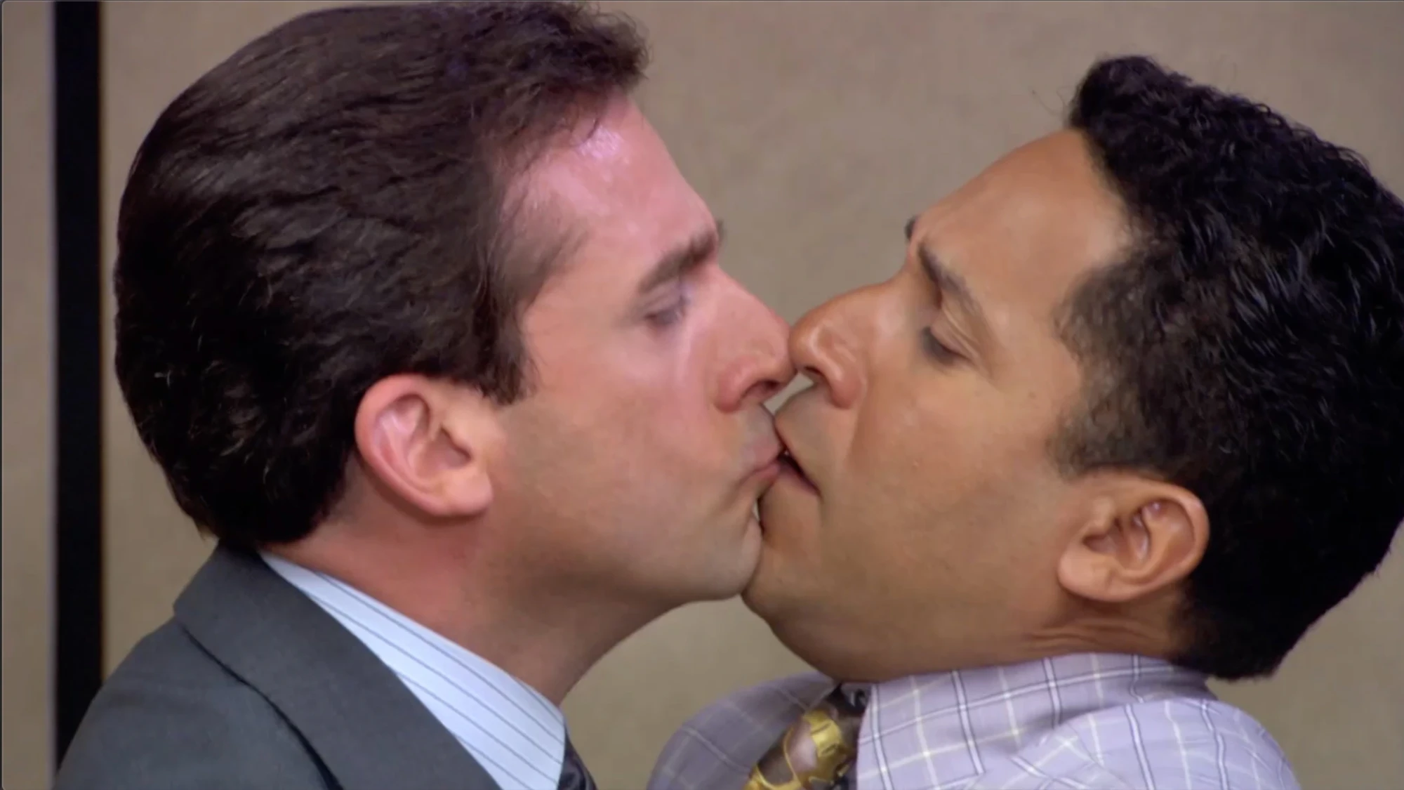 A still from The Office: Michael kisses Oscar.