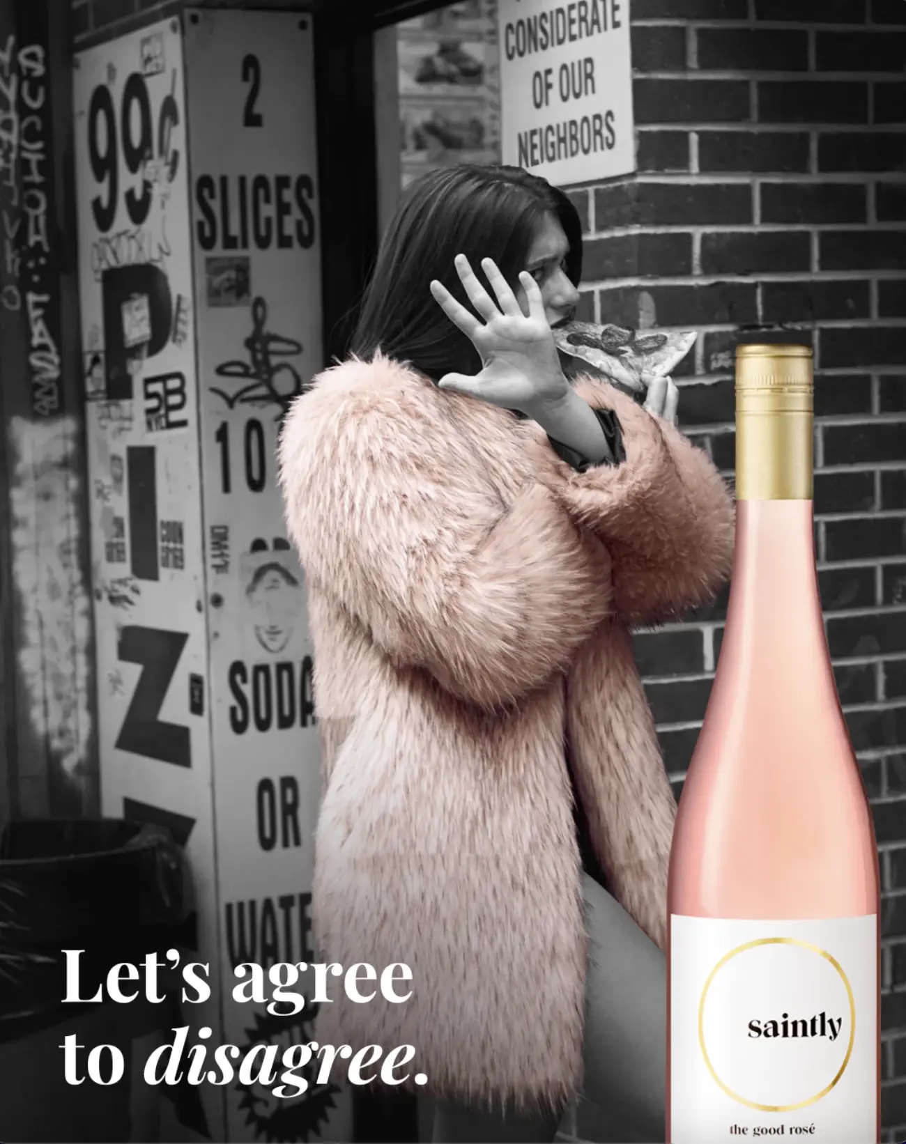Saintly ad: a woman in a pink faux-fur coat eats a slice of pizza outside a pizzeria, beside a bottle of Saintly, with the line &ldquo;Let&rsquo;s agree to disagree.&rdquo;
